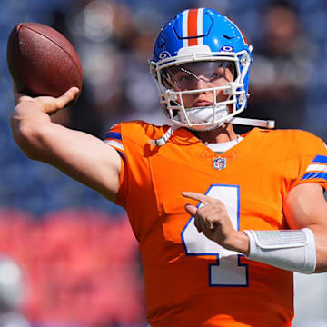 Oct 6, 2024; Denver, Colorado, USA; Denver Broncos quarterback Zach Wilson (4) warms up before the game against the Las Vegas Raiders at Empower Field at Mile High. 