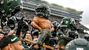 Michigan State celebrates with the Paul Bunyan Trophy after beating Michigan on Saturday, Oct. 30, 2021, at Spartan Stadium in East Lansing.