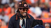 Former Auburn quarterback Cam Newton jokes with his kids on the sideline as Auburn Tigers take on Georgia Bulldogs at Jordan-Hare Stadium in Auburn, Ala. on Saturday, Oct. 11, 2025. Auburn Tigers lead Georgia Bulldogs 10-3 at halftime.