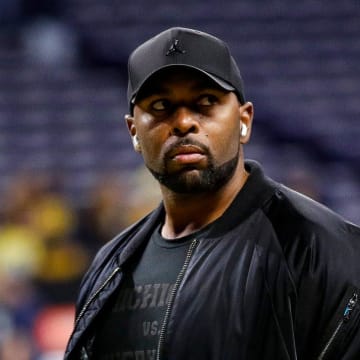 Michigan offensive coordinator Sherrone Moore watches warm up before the Big Ten championship game at Lucas Oil Stadium in Indianapolis on Saturday, Dec. 2, 2023.