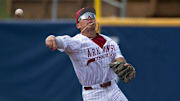 Arkansas Razorbacks' Wehiwa Aloy (9) throws the ball to first base as Arkansas Razorbacks take on Ole Miss Rebels during the SEC baseball tournament at Hoover Met in Birmingham, Ala., on Friday, May 23, 2025.