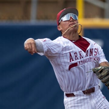 Arkansas Razorbacks' Wehiwa Aloy (9) throws the ball to first base as Arkansas Razorbacks take on Ole Miss Rebels during the SEC baseball tournament at Hoover Met in Birmingham, Ala., on Friday, May 23, 2025.