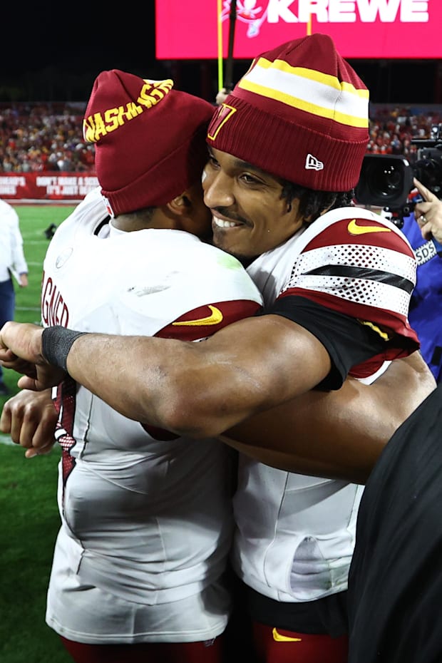 Washington Commanders quarterback Jayden Daniels celebrates with linebacker Bobby Wagner
