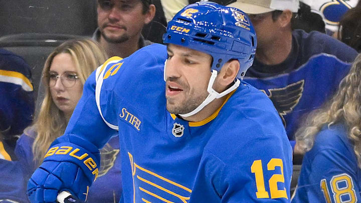 Oct 2, 2025; St. Louis, Missouri, USA; St. Louis Blues left wing Milan Lucic (12) skates against the Ottawa Senators during the second period at Enterprise Center. Mandatory Credit: Jeff Curry-Imagn Images