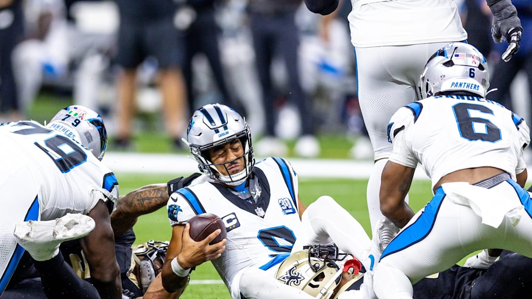 Sep 8, 2024; New Orleans, Louisiana, USA; Carolina Panthers quarterback Bryce Young (9) is tackled as he scrambles out the pocket by New Orleans Saints cornerback Alontae Taylor (1) during the second half at Caesars Superdome.