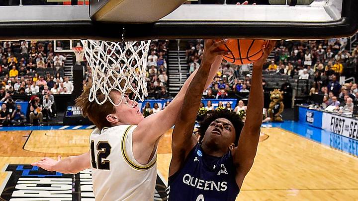 Mar 20, 2026; St. Louis, MO, USA; Queens University of Charlotte Royals guard Jordan Watford (0) goes for a lay up as Purdue Boilermakers center Daniel Jacobsen (12) defends during the first half in a first round game of the men's 2026 NCAA Tournament at Enterprise Center. Mandatory Credit: Jeff Curry-Imagn Images