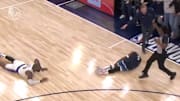 Minnesota Timberwolves guard Anthony Edwards grabs his leg in pain after a collision with Los Angeles Lakers forward LeBron James.