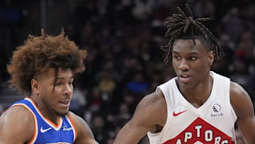 Toronto Raptors guard Ja'Kobe Walter drives to the paint against New York Knicks guard Miles McBride.