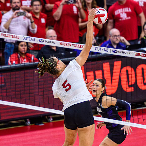 Rebekah Allick (5) gets the kill on match point to finish the Huskers' sweep of Washington. 