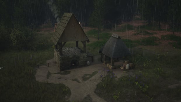 Manor Lords screenshot showing a Malthouse in the rain.