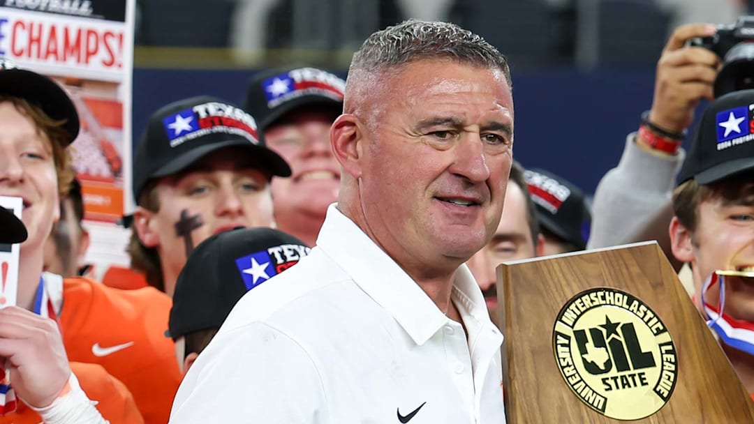 Bill Elliott, Celina head football coach and AD, holds the trophy following his team's victory over Kilgore in the Texas 4A Division 1 title game at AT&T Stadium in 2024. Elliott announced his retirement on Wednesday after 33 years. 