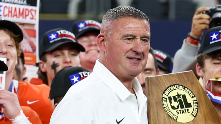 Bill Elliott, Celina head football coach and AD, holds the trophy following his team's victory over Kilgore in the Texas 4A Division 1 title game at AT&T Stadium in 2024. Elliott announced his retirement on Wednesday after 33 years. 