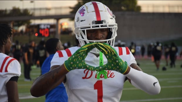 Dakorien Moore flashes Oregon Ducks gloves before his first game of his senior year at Duncanville High School.