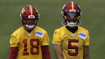 Jun 10, 2025; Ashburn, VA, USA; Washington Commanders quarterback Jayden Daniels (5) and Commanders quarterback Marcus Mariota (18) walk down the field on day one of minicamp at Commanders Park. Mandatory Credit: Geoff Burke-Imagn Images