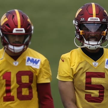 Jun 10, 2025; Ashburn, VA, USA; Washington Commanders quarterback Jayden Daniels (5) and Commanders quarterback Marcus Mariota (18) walk down the field on day one of minicamp at Commanders Park. Mandatory Credit: Geoff Burke-Imagn Images
