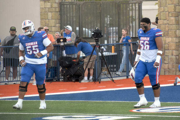 Bishop Gorman players Alai Kalaniuvalu (55) and Doug Utu (56) warm up before their game vs. Kahuku on Friday, Aug. 16.