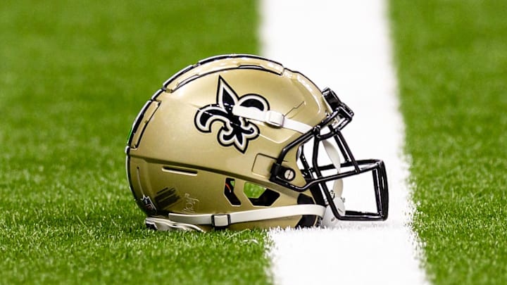 Aug 25, 2024; New Orleans, Louisiana, USA;  New Orleans Saints helmet on the turf during warmups before the game against the Tennessee Titans at Caesars Superdome. Mandatory Credit: Stephen Lew-Imagn Images