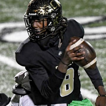 Gaffney quarterback Jayvon Gilmore (8) runs from TL Hanna junior Jameerion Oliver (0) during the second quarter of State Class 5A football playoffs at Gaffney High School in Gaffney, S.C. Friday, November 29, 2024.