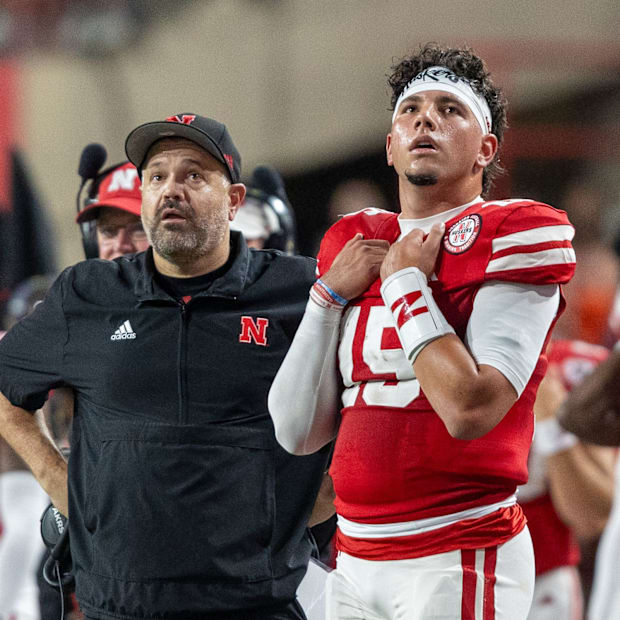Nebraska Head Coach Matt Rhule and quarterback Dyaln Raiola look up at the scoreboard during the Illinois game.