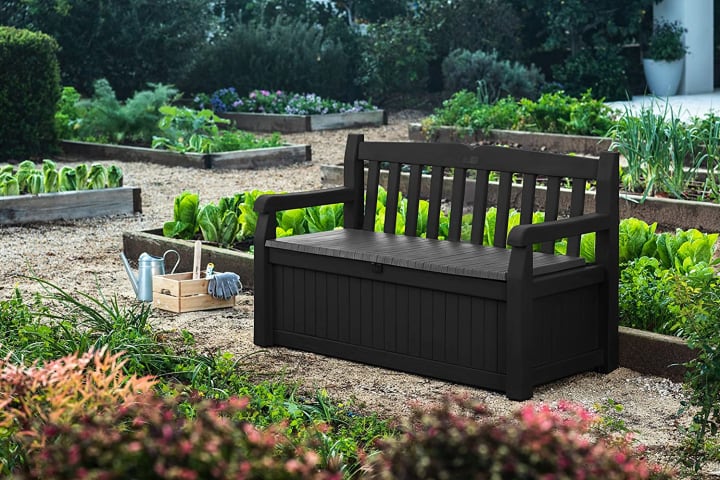 Keter Solana 70-Gallon Storage Bench Deck Box from Amazon in a garden.