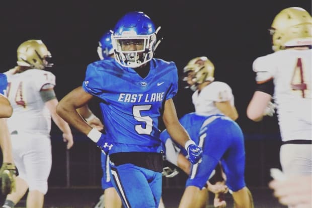 Football player Micah Abraham looks on after a play in a blue jersey.