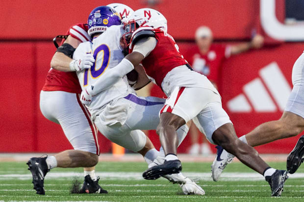 Nebraska defensive backs Marques Buford Jr. and Isaac Gifford combine to bring down Northern Iowa's Aidan Dunne.