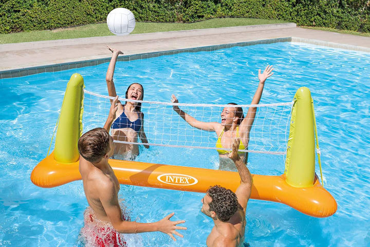 People playing an Intex volleyball game in a pool