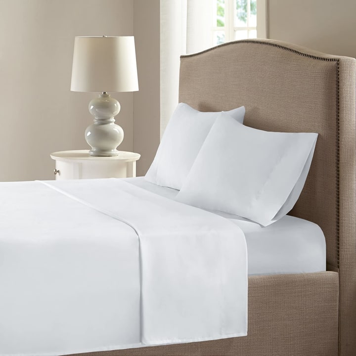 A set of Comfort Spaces COOLMAX Cooling Sheets on a bed in a bedroom.
