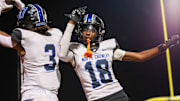 North Crowley's Kevin Moore (left) celebrates a touchdown with fellow senior wideout Jaidan Brooks earlier this season. North Crowley defeated Crowley 65-21 last week.