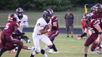 Bellefontaine's Tavien St. Clair breaks into the center of the Licking Heights defense during the host Hornets' 45-14 loss on Friday, Sept. 1, 2023.