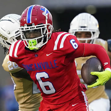 Duncanville's Trenton Yancey runs away from a defender in a game against Dallas South Oak Cliff earlier this year. 