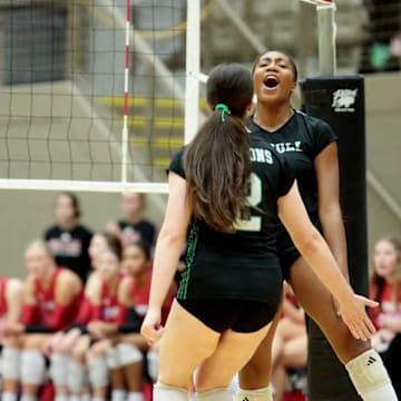 Three Southlake Dragons players celebrate a point during a match against Tomball on Nov. 15 