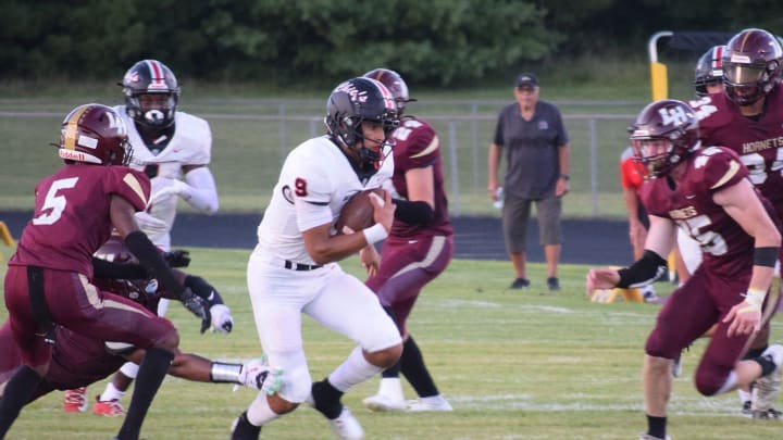 Bellefontaine's Tavien St. Clair breaks into the center of the Licking Heights defense during the host Hornets' 45-14 loss on Friday, Sept. 1, 2023.