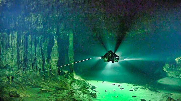 A diver swims through the Ox Bel Ha cave system.