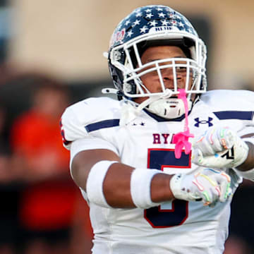 Denton Billy Ryan's Uzziah Warmate celebrates a tackle against Aledo.