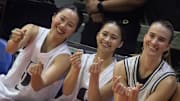 Sabrina Ionescu poses for photos alongside Filipino players Kaye Pesquera and Kai Oani.
