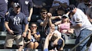 Apr 14, 2024; Cleveland, Ohio, USA; A fan catches a foul ball during the seventh inning between the Cleveland Guardians and the New York Yankees at Progressive Field. 