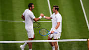 Maric Cilic and Jack Draper shake hands after their match at Wimbledon.