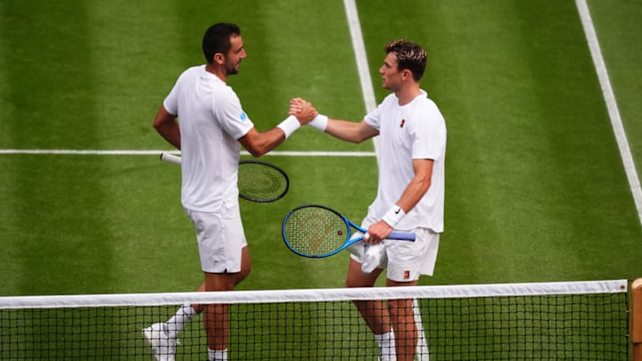 Maric Cilic and Jack Draper shake hands after their match at Wimbledon.