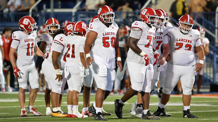 Orange Lutheran offense breaks huddle before an offensive play.