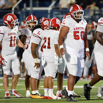 Orange Lutheran offense breaks huddle before an offensive play.