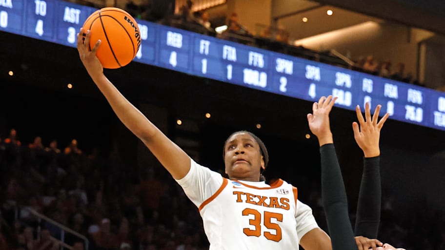 Madison Booker of Texas goes to the basket against Oregon.