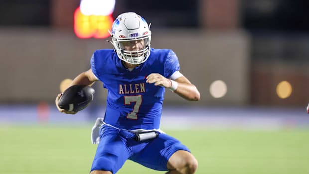 Allen's Brady Bricker evades a tackler against Cedar Hill in the 2024 Texas high school football season. 