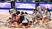 Members of the Mater Dei rush to celebrate their three set sweep of Rocklin in the California Open Division state final at Santiago Canyon College.