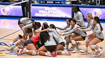 Members of the Mater Dei rush to celebrate their three set sweep of Rocklin in the California Open Division state final at Santiago Canyon College.