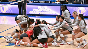 Members of the Mater Dei rush to celebrate their three set sweep of Rocklin in the California Open Division state final at Santiago Canyon College.