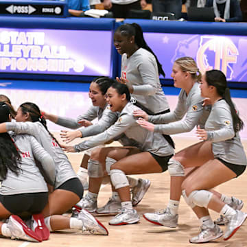 Members of the Mater Dei rush to celebrate their three set sweep of Rocklin in the California Open Division state final at Santiago Canyon College.