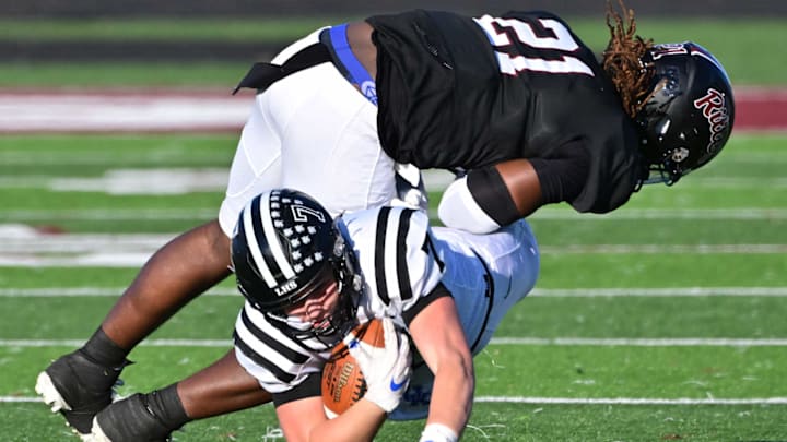 Cardinal Ritter sophomore linebacker Marshaun Ivy (21) puts a hit on a Lafayette (Mo.) runner during a 2024 game. Cardinal Ritter sophomore linebacker Marshaun Ivy (21) puts a hit on a Lafayette (Mo.) runner during a 2024 game.