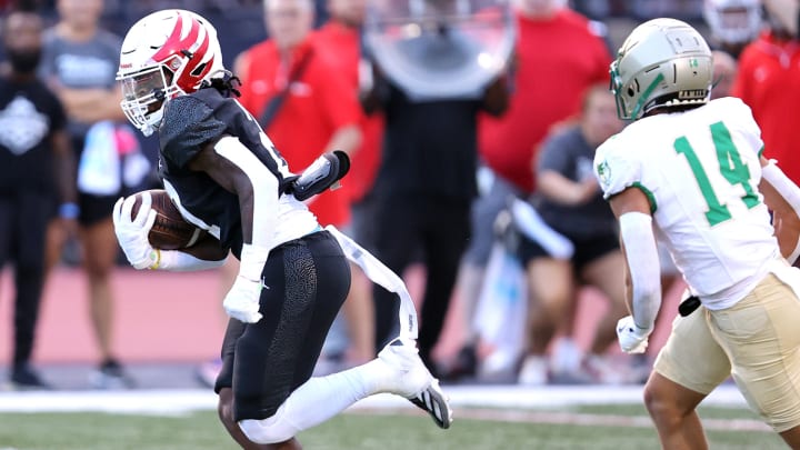 Milton running back TJ Lester runs for yardage in a 2024 season opening match-up with Buford.