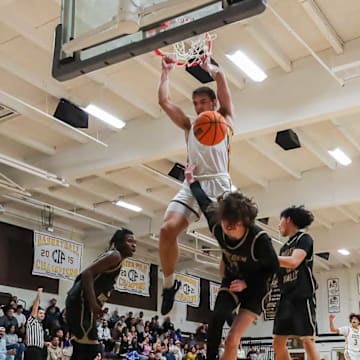 Crespi senior forward Peyton White throws down a dunk against Golden Valley at home.